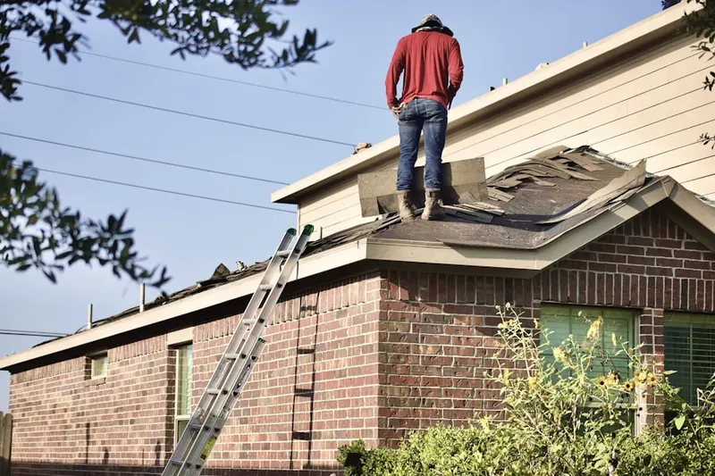 Professional roofer working on a residential roof in Altamont